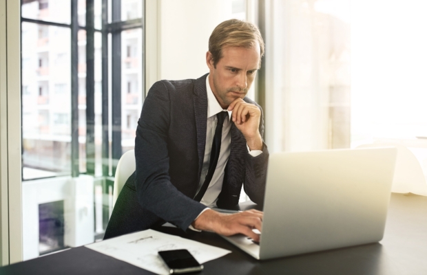 focused-task-hand-shot-businessman-using-his-laptop-min